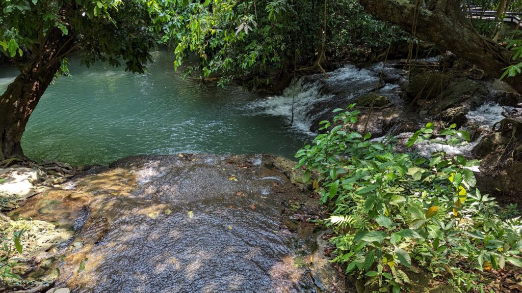 small waterfall flowing over rocks into a large rockpool at Thanbok Khoranee National Park